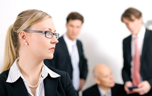 men talking behind womans back - FMLA Retaliation